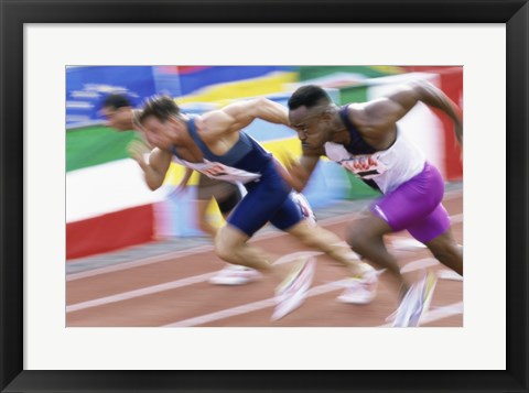 Framed Side profile of three men running low on a running track Print