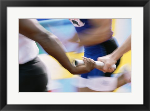 Framed Mid section view of runners exchanging baton at a relay race Print