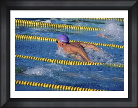 Framed Swimmer racing in a swimming pool Print