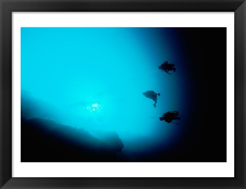 Framed Three scuba divers swimming underwater, Blue Hole, Belize Print