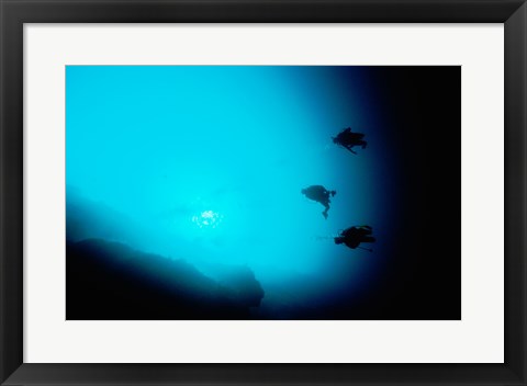 Framed Three scuba divers swimming underwater, Blue Hole, Belize Print