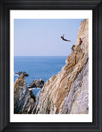 Framed Male cliff diver jumping off a cliff, La Quebrada, Acapulco, Mexico Print