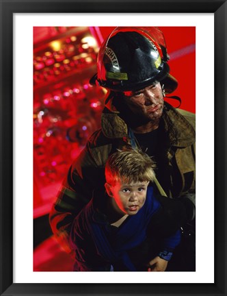 Framed Close-up of a firefighter carrying a boy Print