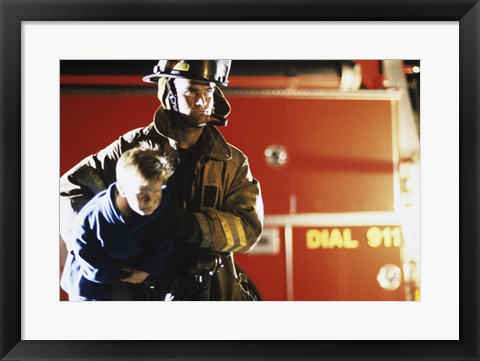 Framed Close-up of a firefighter carrying a boy Print