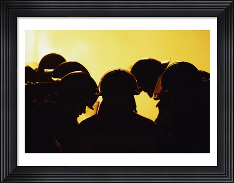 Framed Rear view of a group of firefighters looking down Print