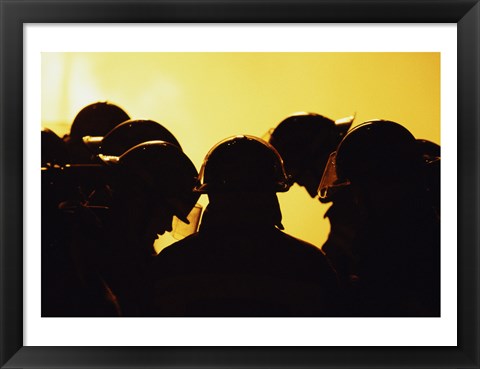 Framed Rear view of a group of firefighters looking down Print