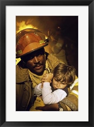 Framed Firefighter carrying a boy Print