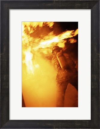 Framed Fireman fighting with fire flames Print