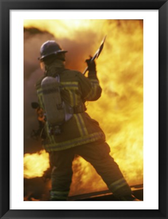 Framed Rear view of a firefighter holding an axe Print