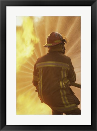 Framed Rear view of a firefighter extinguishing a fire Print