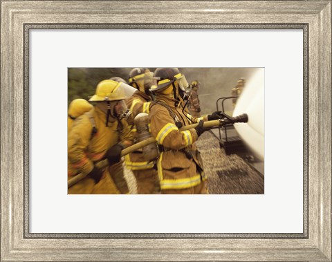 Framed Side profile of a group of firefighters holding water hoses Print