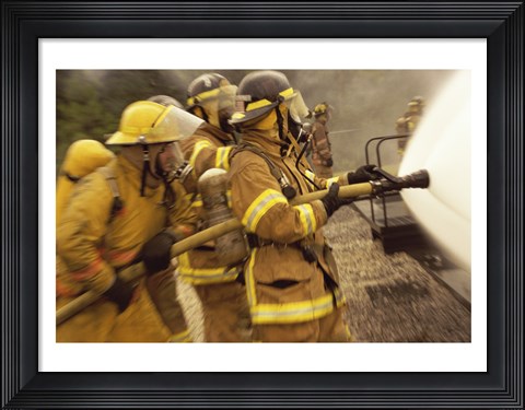 Framed Side profile of a group of firefighters holding water hoses Print