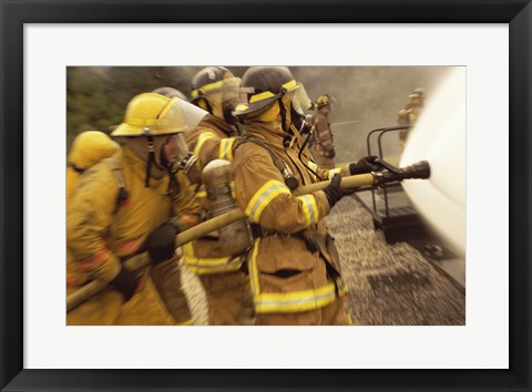 Framed Side profile of a group of firefighters holding water hoses Print