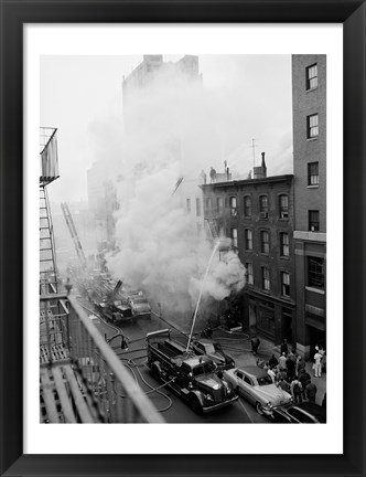 Framed New York City, Fire on East 47th Street, with fire engines shooting water on burning building Print