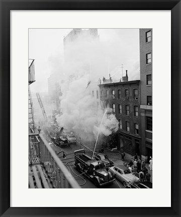 Framed New York City, Fire on East 47th Street, with fire engines shooting water on burning building Print