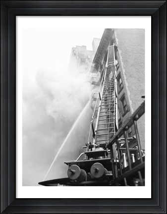 Framed Fire engine with ladder up burning building Print