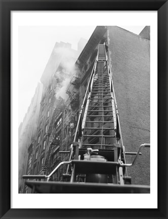 Framed Fire engine with ladder up burning building Print