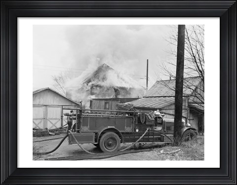 Framed Fire engine next to home in fire Print