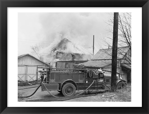 Framed Fire engine next to home in fire Print