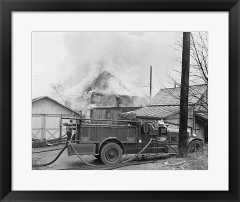 Framed Fire engine next to home in fire Print