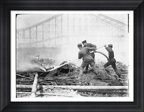 Framed Three firefighters extinguishing a fire Print