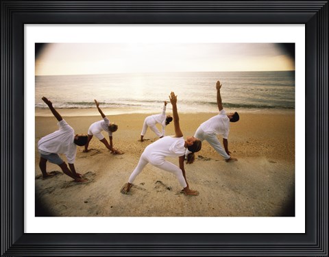 Framed Group of people performing yoga on the beach Print