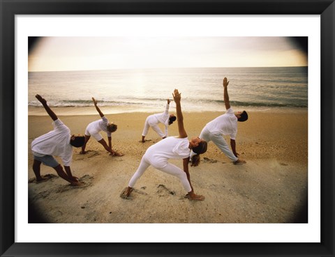 Framed Group of people performing yoga on the beach Print