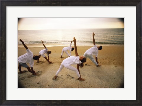 Framed Group of people performing yoga on the beach Print