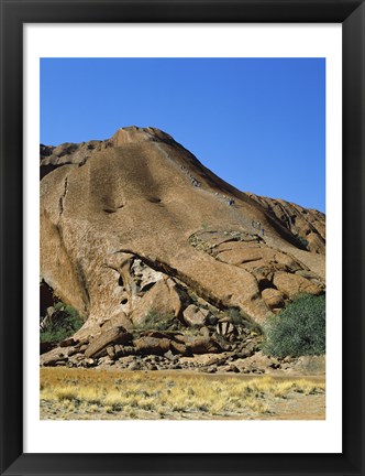 Framed Tourists climbing on a rock, Ayers Rock, Uluru-Kata Tjuta National Park, Australia Print