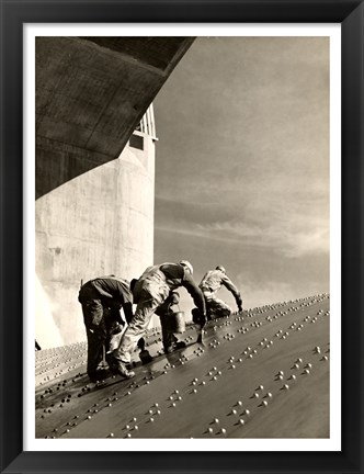 Framed Three construction workers putting a coat of paint on a slanted wall of riveted-steel plates on the Hoover Dam spillway Print