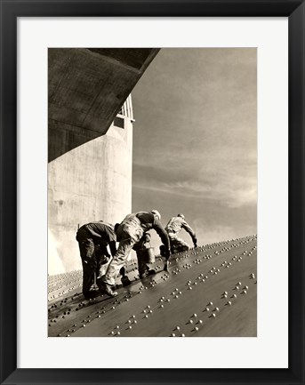 Framed Three construction workers putting a coat of paint on a slanted wall of riveted-steel plates on the Hoover Dam spillway Print