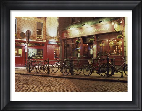 Framed Bicycles parked in front of a restaurant at night, Dublin, Ireland Print