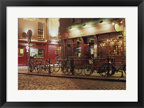 Framed Bicycles parked in front of a restaurant at night, Dublin, Ireland Print