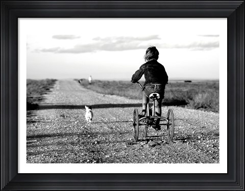 Framed Rear view of a girl riding a bicycle Print