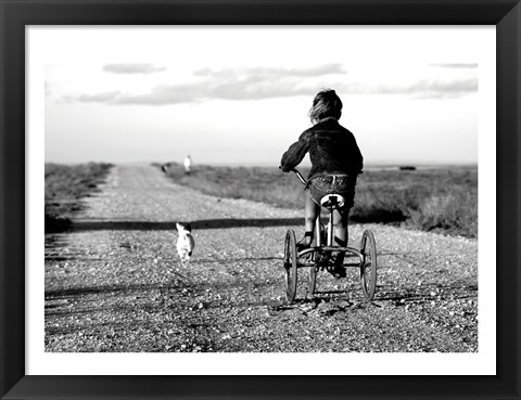 Framed Rear view of a girl riding a bicycle Print