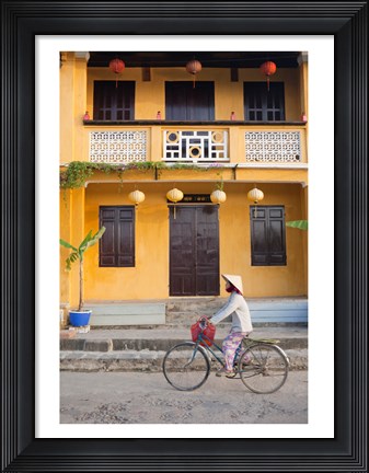 Framed Person riding a bicycle in front of a cafe, Hoi An, Vietnam Print