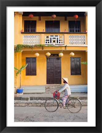 Framed Person riding a bicycle in front of a cafe, Hoi An, Vietnam Print