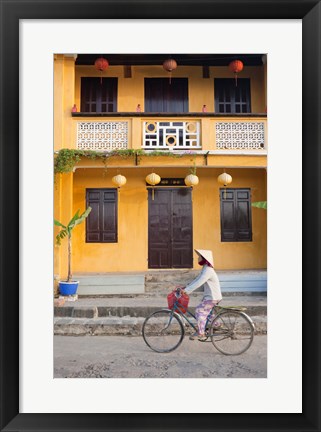 Framed Person riding a bicycle in front of a cafe, Hoi An, Vietnam Print