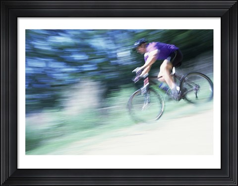 Framed Side profile of a young man riding a bicycle Print