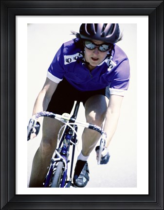 Framed Young woman riding a bicycle Print