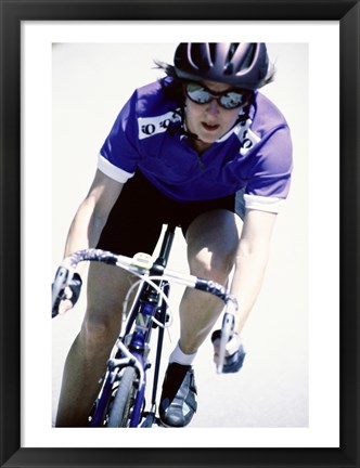 Framed Young woman riding a bicycle Print