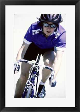 Framed Young woman riding a bicycle Print