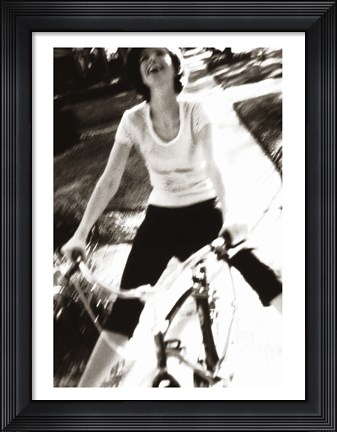 Framed Young woman riding a bicycle - black &amp; white Print