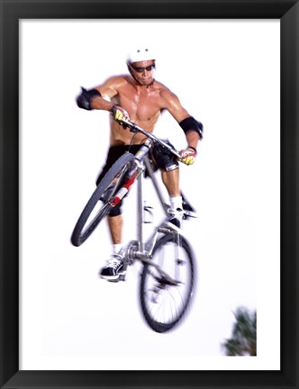 Framed Young man on a bicycle in mid-air Print