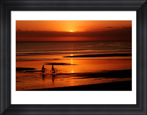 Framed Silhouette of a young couple cycling on the beach Print