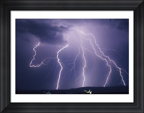 Framed Lightning bolts striking the earth Print