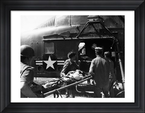 Framed Army soldiers carrying an injured person in a helicopter Print