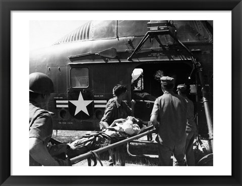 Framed Army soldiers carrying an injured person in a helicopter Print