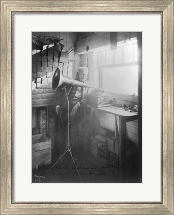 Framed Thomas Alva Edison, full-length portrait, standing, facing right, listening to a new record Print