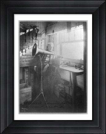 Framed Thomas Alva Edison, full-length portrait, standing, facing right, listening to a new record Print